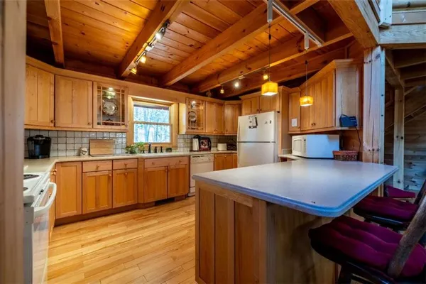 a kitchen with a appliances cabinets and a counter top space