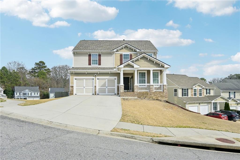 a front view of a house with a yard and garage