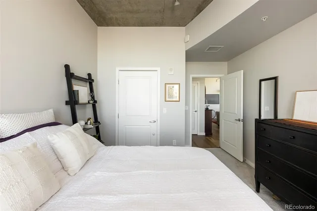 a bedroom with a bed and a dresser