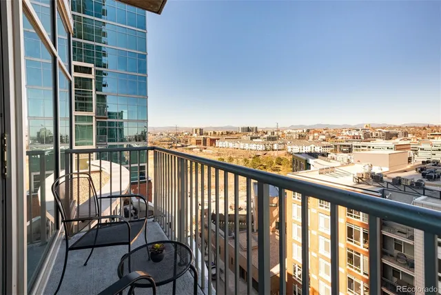 a view of a balcony with furniture and city view