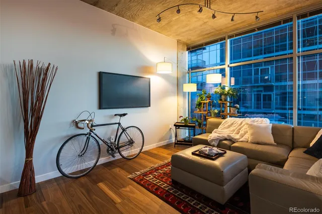 a living room with furniture a flat screen tv and a table