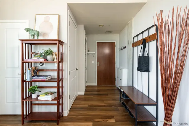 a view of a hallway with wooden floor and entryway