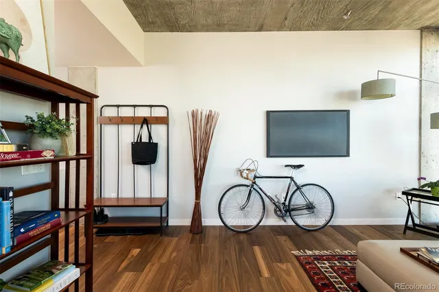 a living room with furniture a flat screen tv and a floor to ceiling window