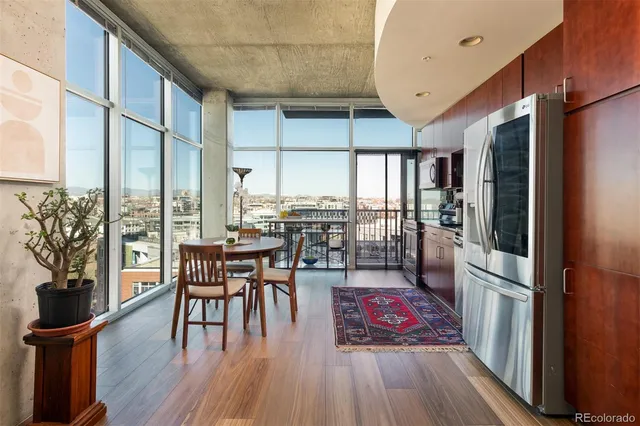 an outdoor space with lots of chairs and wooden floor