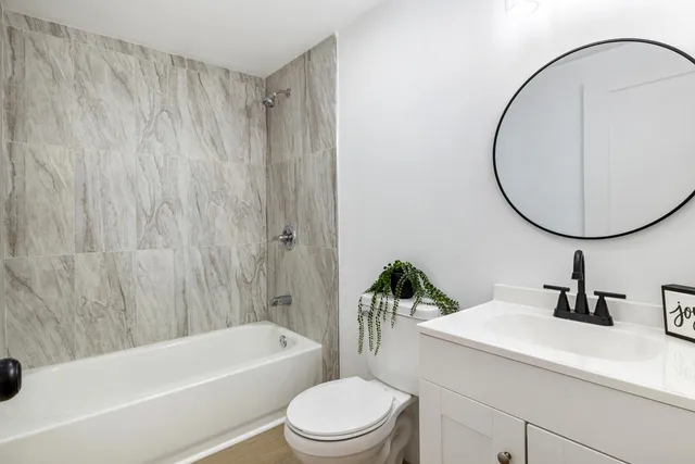 a bathroom with a sink a toilet and a mirror