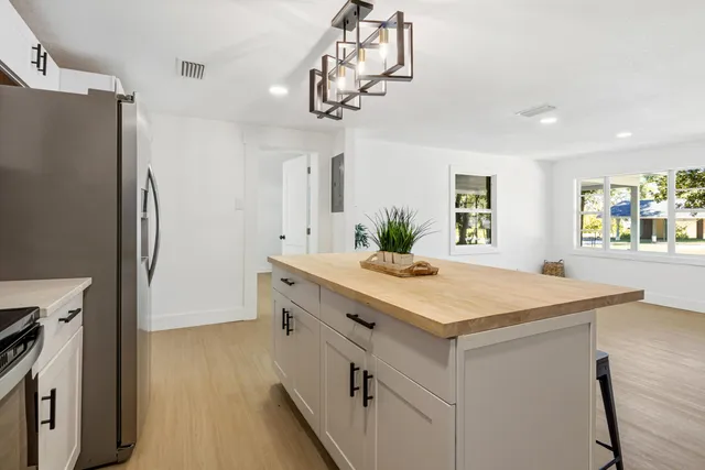 a bathroom with a sink a mirror and a shower