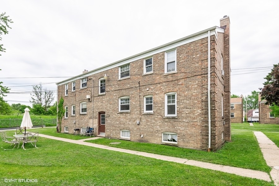 4246 West Nelson Street, Unit 2 Chicago, IL 60641 - Photo 12 of 12 a brick building with a yard