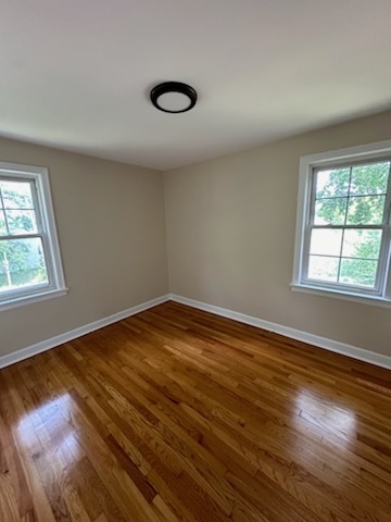 4246 West Nelson Street, Unit 2 Chicago, IL 60641 - Photo 7 of 12 a view of empty room with wooden floor and fan