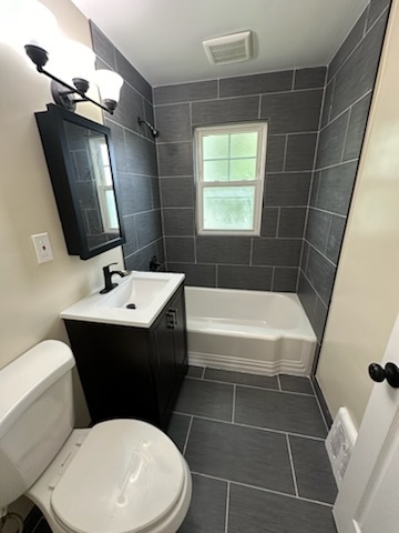4246 West Nelson Street, Unit 2 Chicago, IL 60641 - Photo 9 of 12 a bathroom with a toilet a sink and bathtub