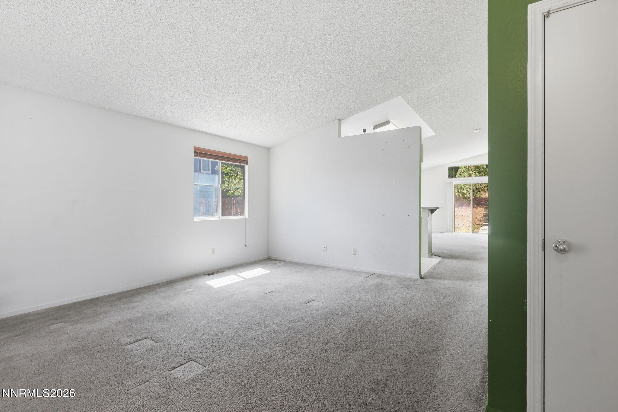 6840 Viscaya Court Reno, NV 89523 - Photo 12 of 25 an empty room with a window and a kitchen
