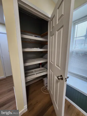 a view of walk in closet with empty racks