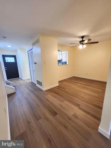 wooden floor in an empty room with a window