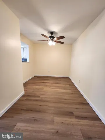 a view of an empty room with a ceiling fan