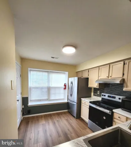 a kitchen with refrigerator and window