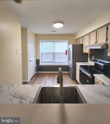 a kitchen with a refrigerator sink and stove