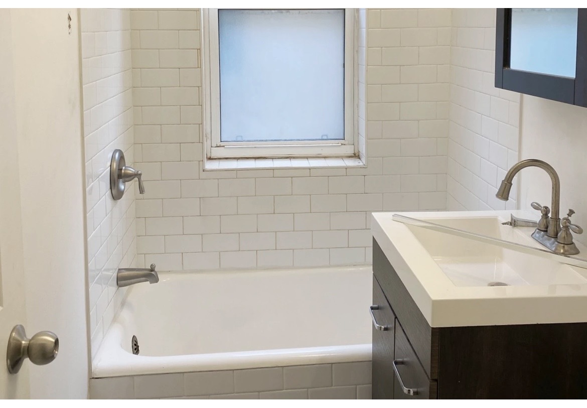 4218 North Clark Street, Unit 2 Chicago, IL 60613 - Photo 12 of 12 a bathroom with a sink and a bathtub