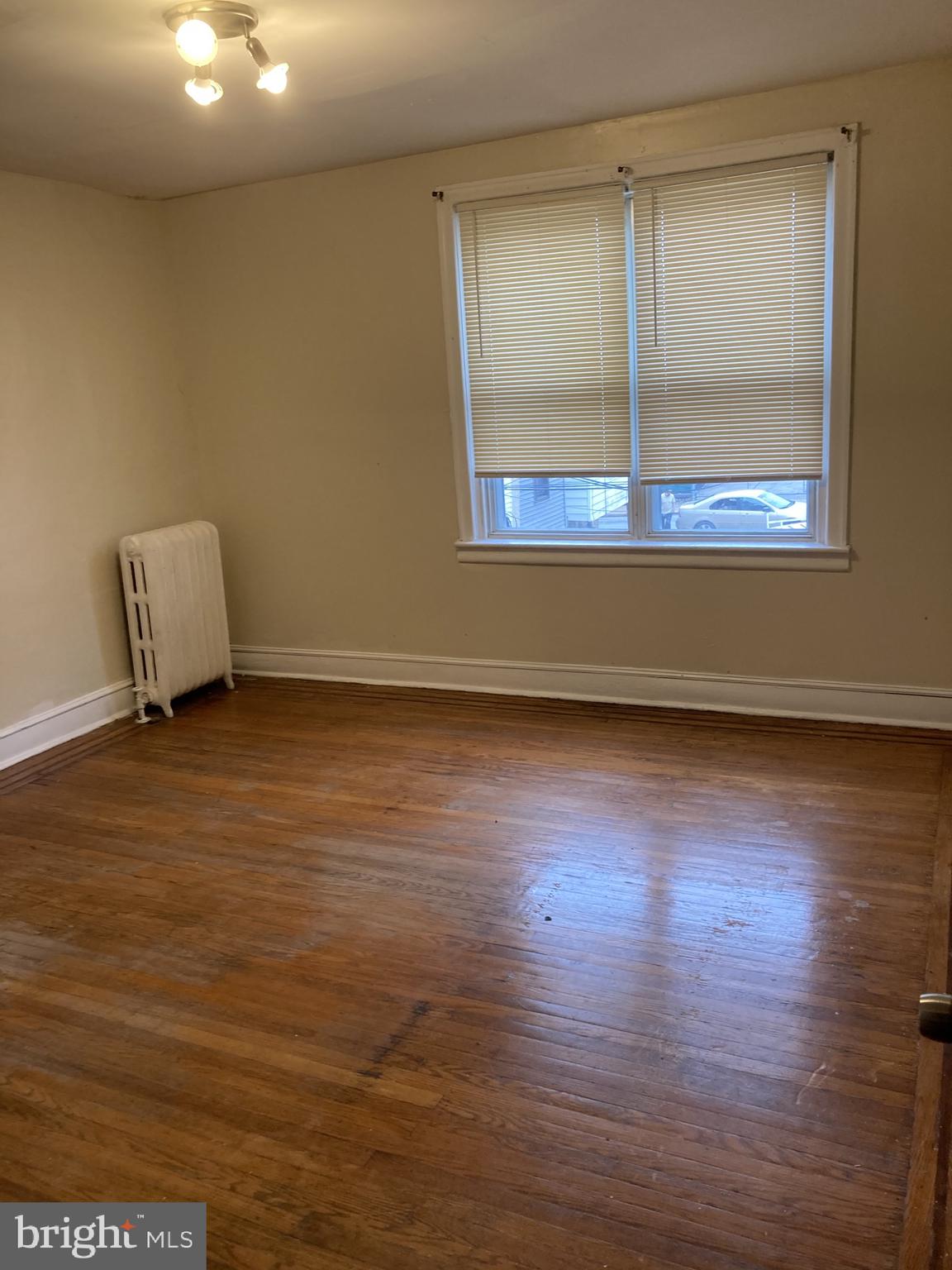 3145 North Patton Street Philadelphia, PA 19132 - Photo 13 of 16 a view of room and wooden floor