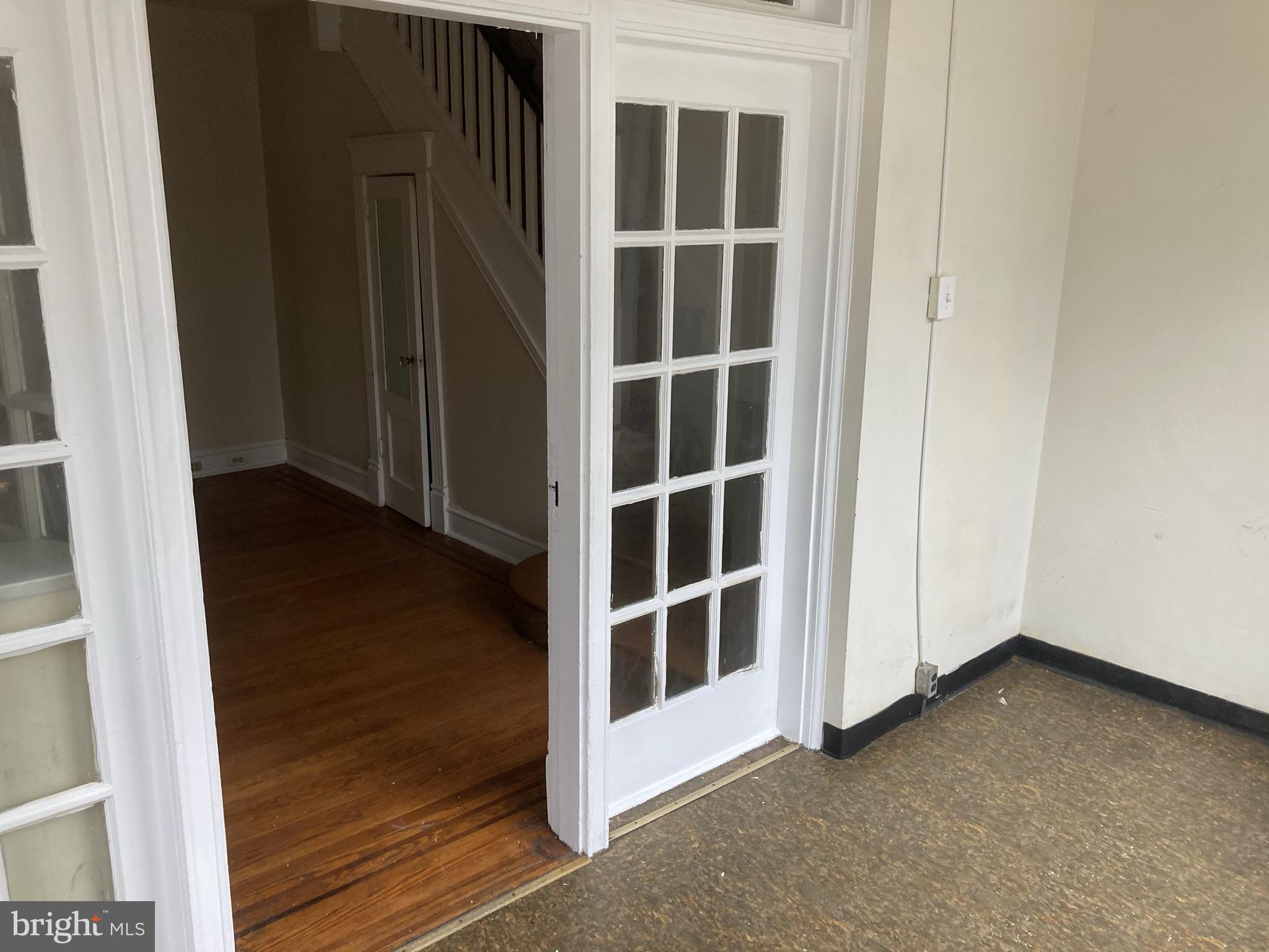 3145 North Patton Street Philadelphia, PA 19132 - Photo 2 of 16 a view of an empty room with wooden floor and windows