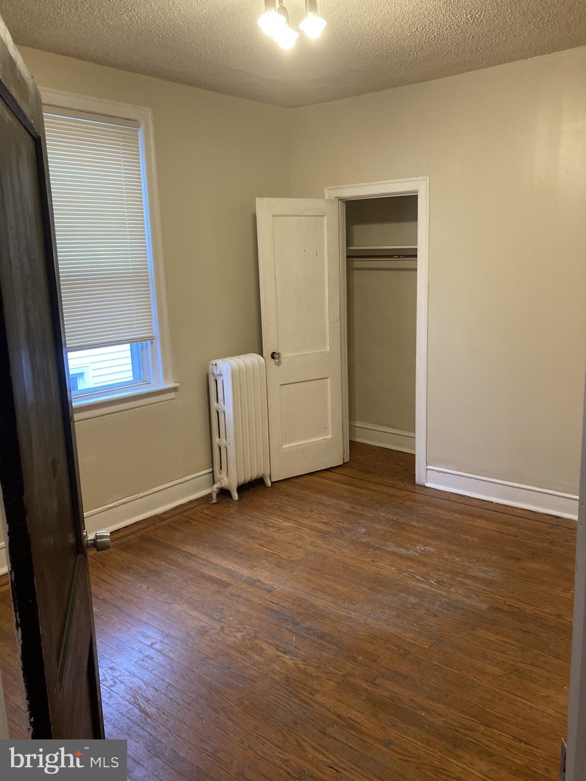 3145 North Patton Street Philadelphia, PA 19132 - Photo 9 of 16 an empty room with wooden floor and windows