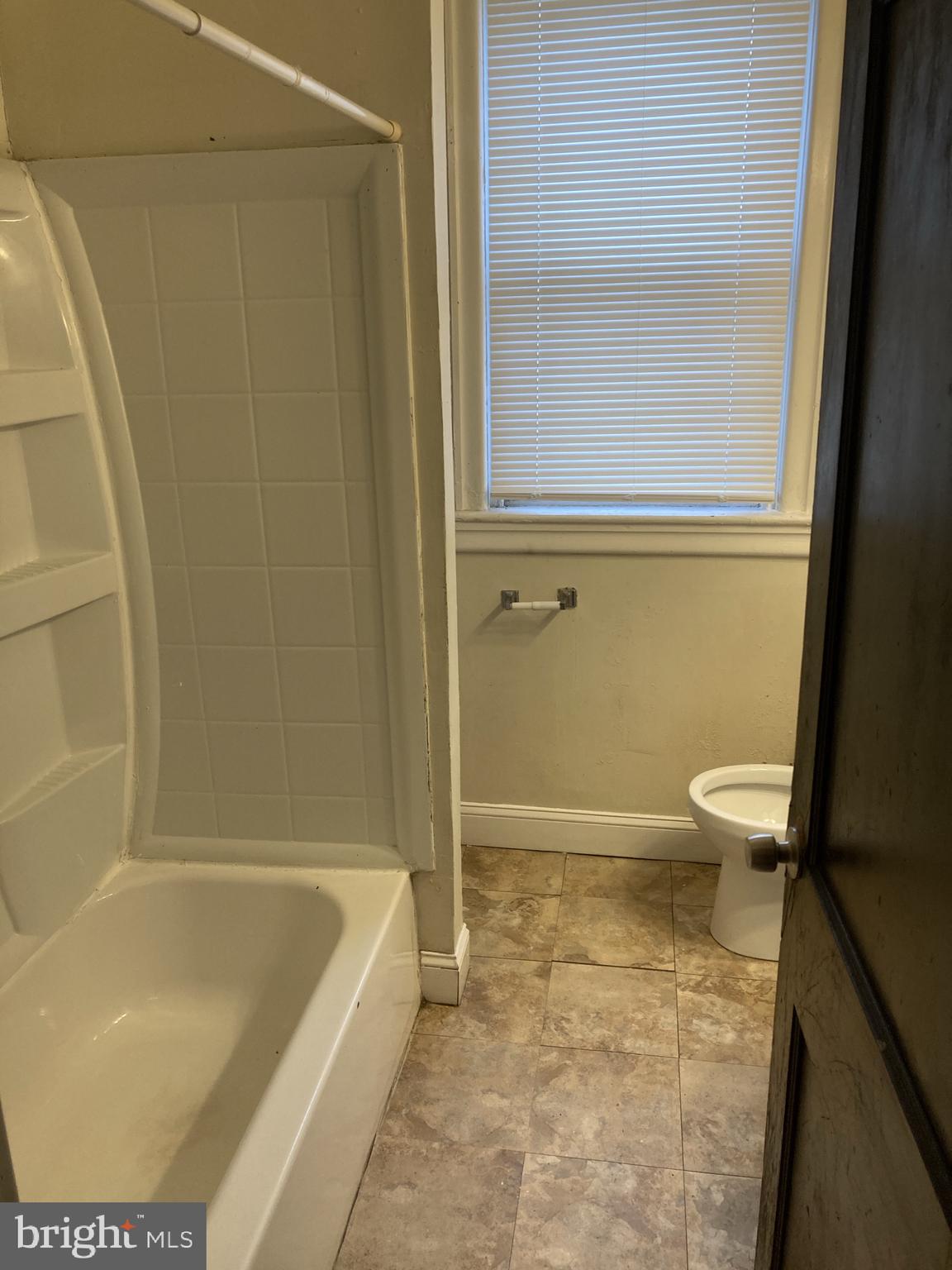 3145 North Patton Street Philadelphia, PA 19132 - Photo 10 of 16 a bathroom with a tub and toilet