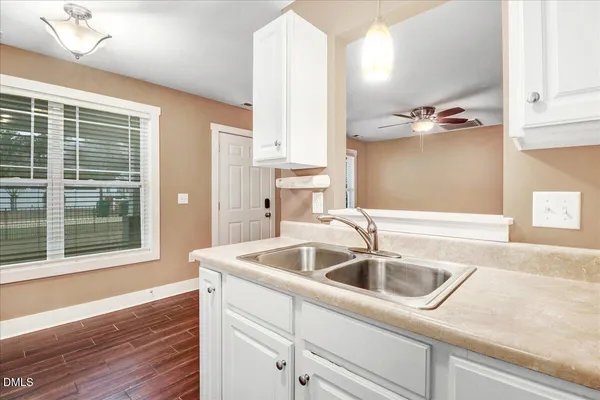 a kitchen with a sink and large window