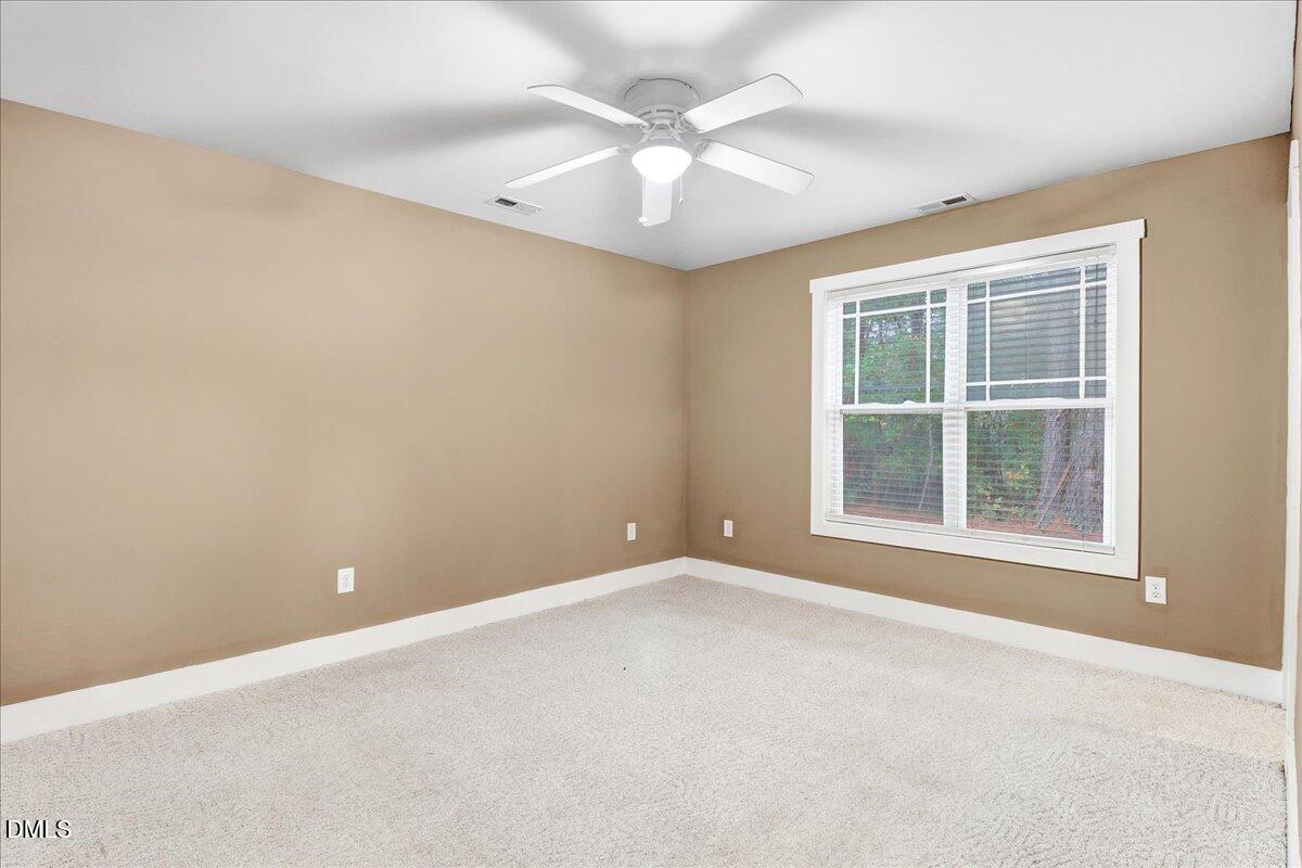 51 Birch Street Elizabethtown, NC 28337 - Photo 18 of 42 an empty room with windows and ceiling fan