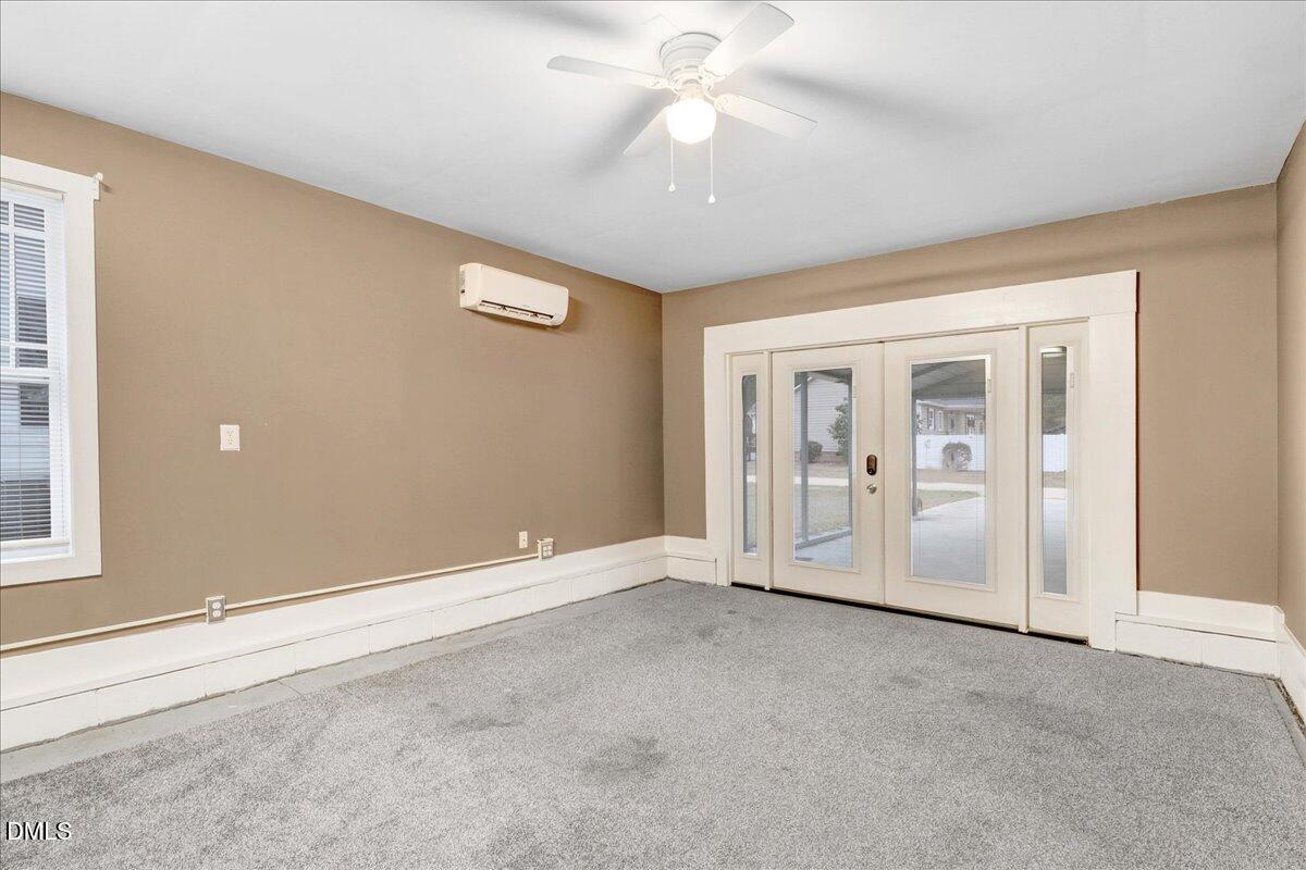 51 Birch Street Elizabethtown, NC 28337 - Photo 23 of 42 an empty room with chandelier fan and windows
