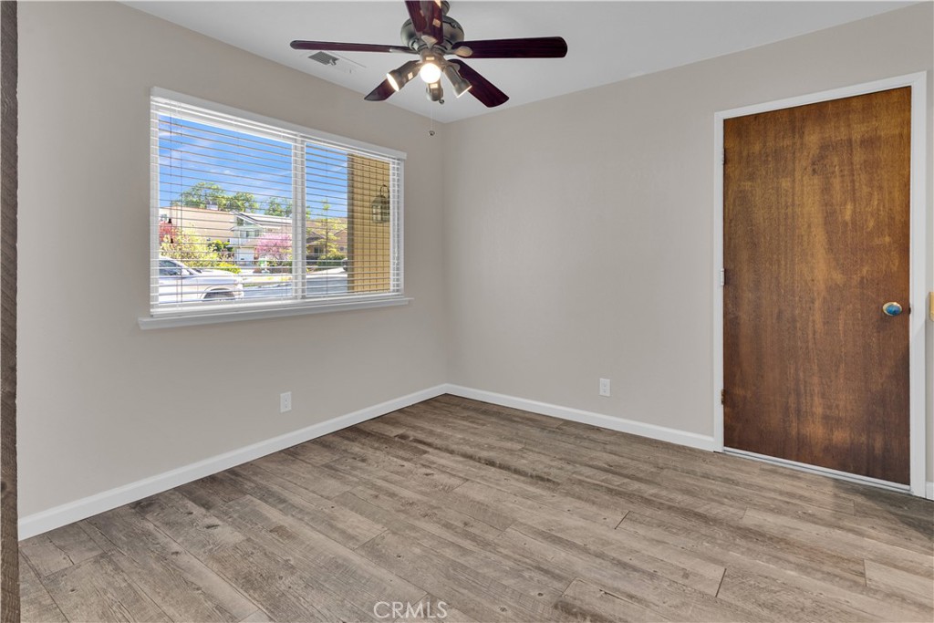 1991 Brook Lane Paso Robles, CA 93446 - Photo 7 of 29 a view of an empty room with wooden floor and window