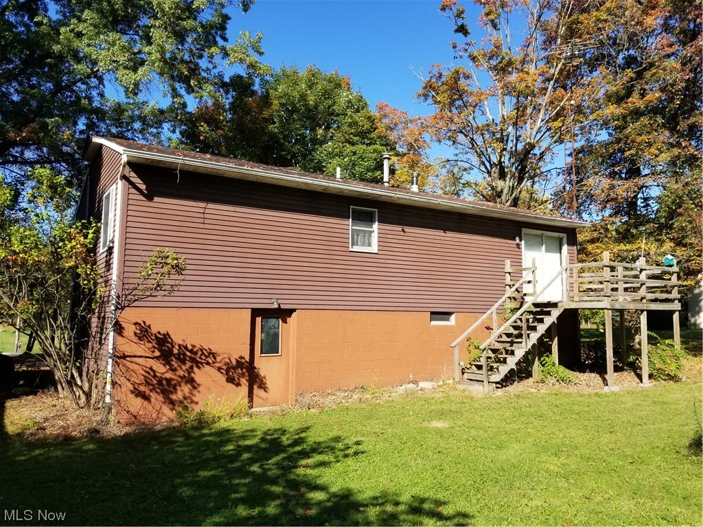 756 Cunningham Road Salem, OH 44460 - Photo 22 of 25 View of side of property featuring a deck and a lawn