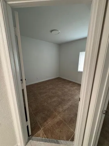 a view of a hallway with wooden floor and stairs