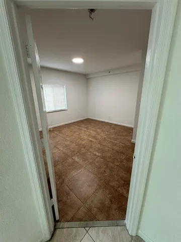 an empty room with a wooden door