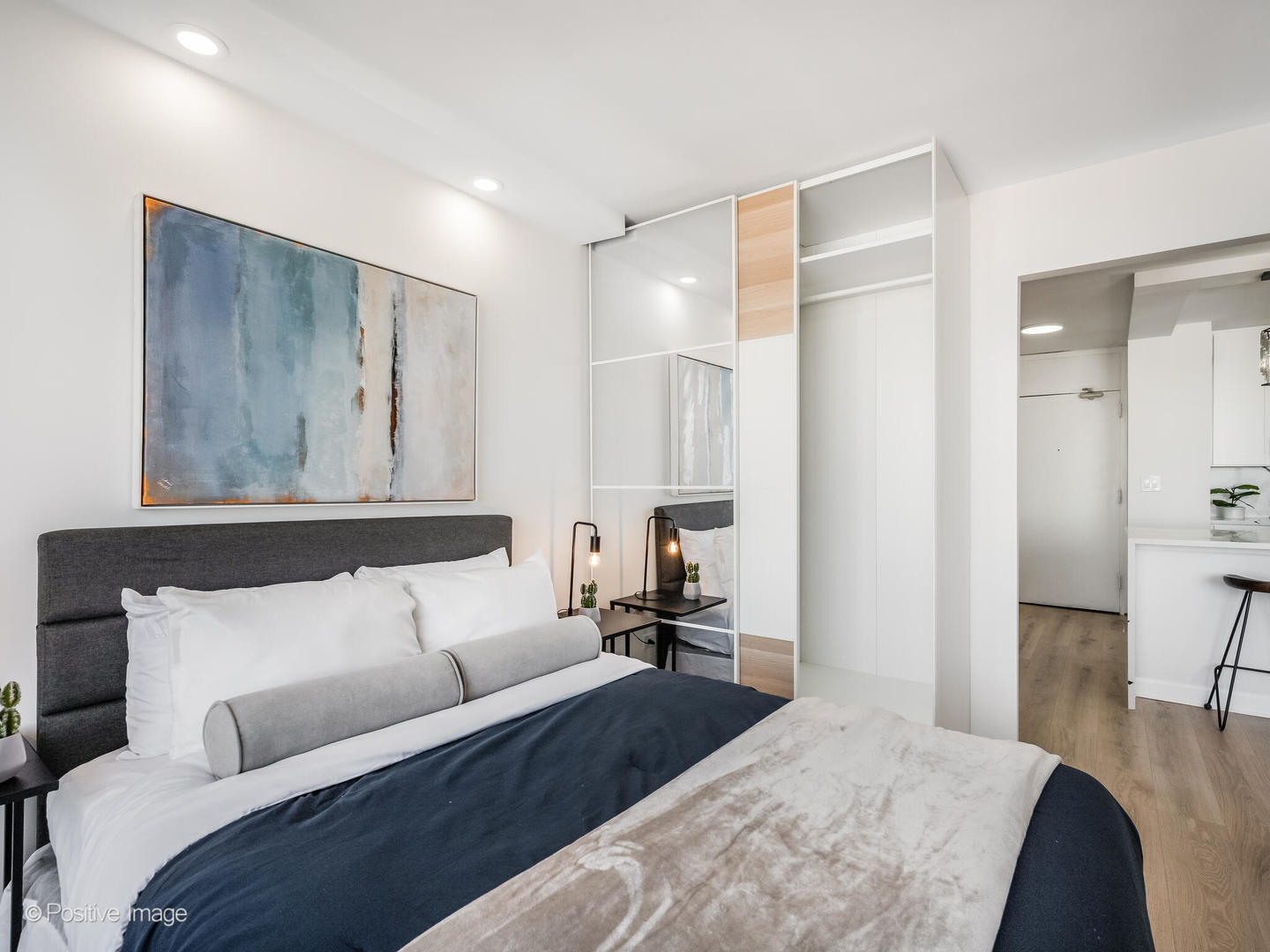 5455 North Sheridan Road, Unit 3203 Chicago, IL 60640 - Photo 12 of 21 a bedroom with a bed and a couch