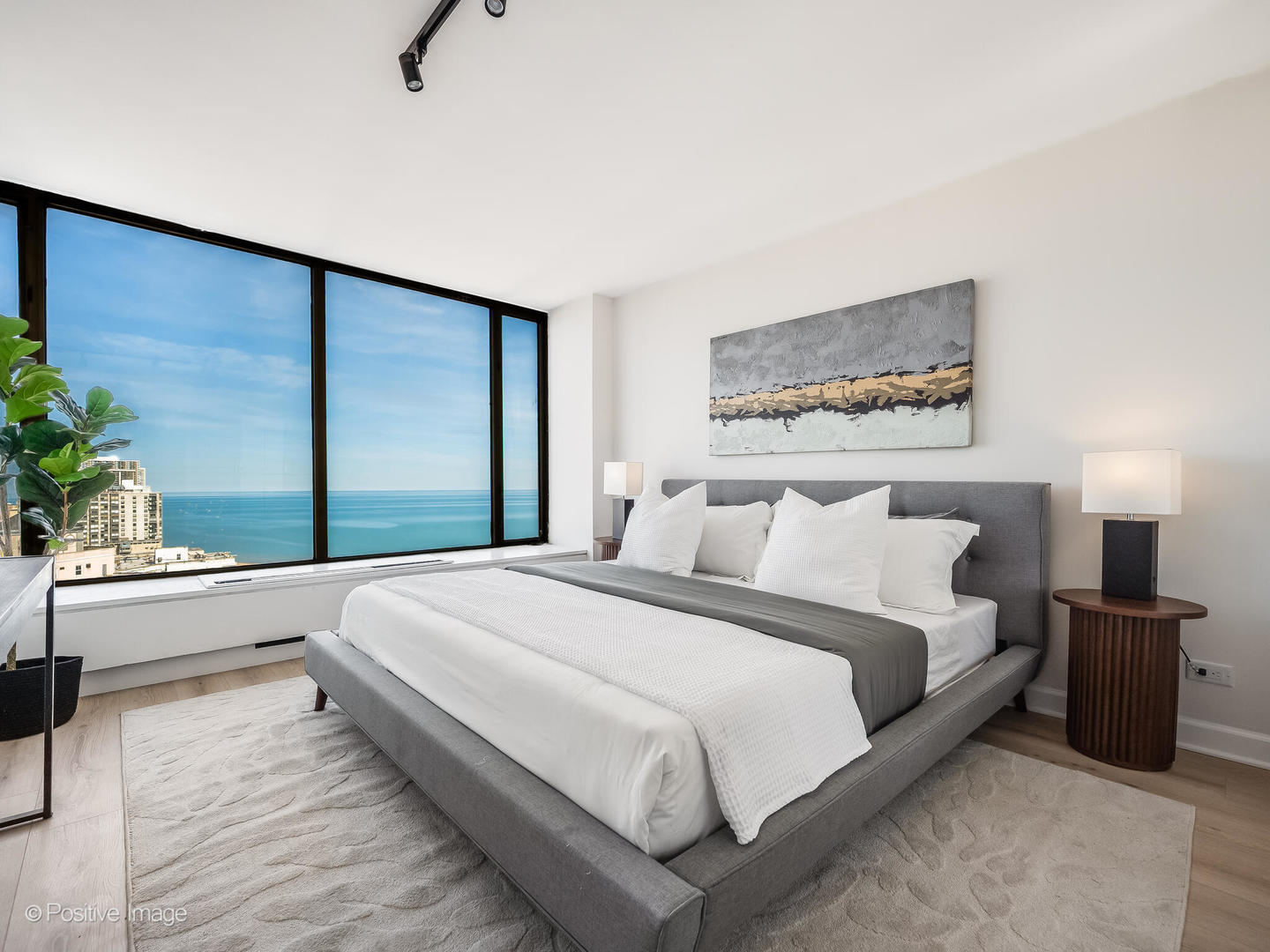 5455 North Sheridan Road, Unit 3203 Chicago, IL 60640 - Photo 14 of 21 a bedroom with a large bed and a large window