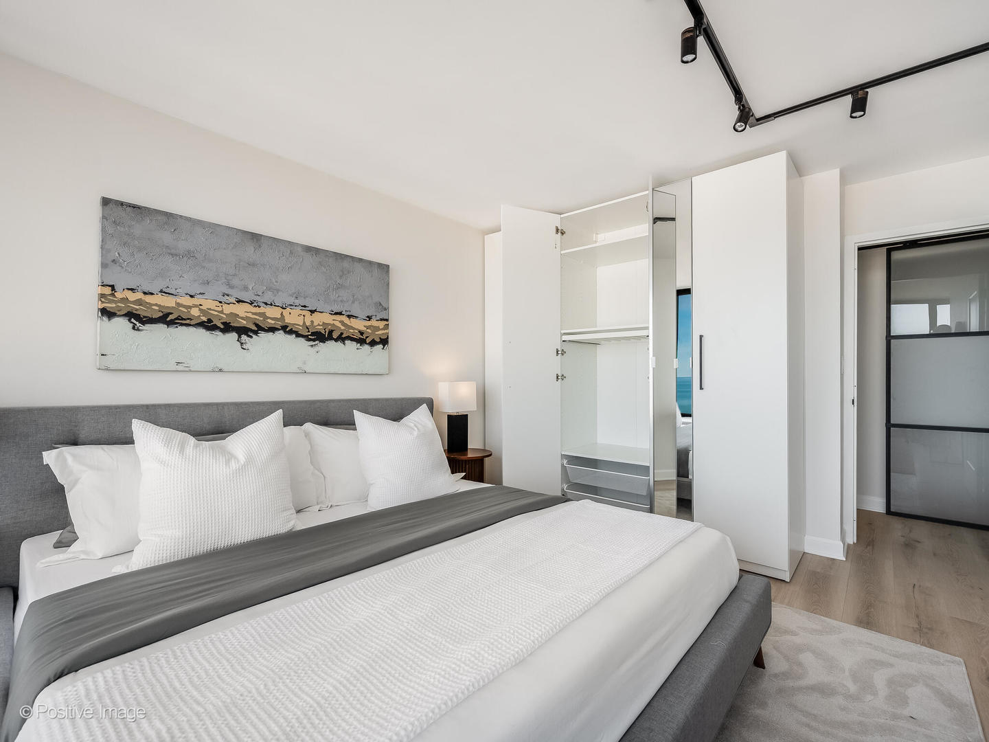 5455 North Sheridan Road, Unit 3203 Chicago, IL 60640 - Photo 15 of 21 a bedroom with a bed and wooden floor