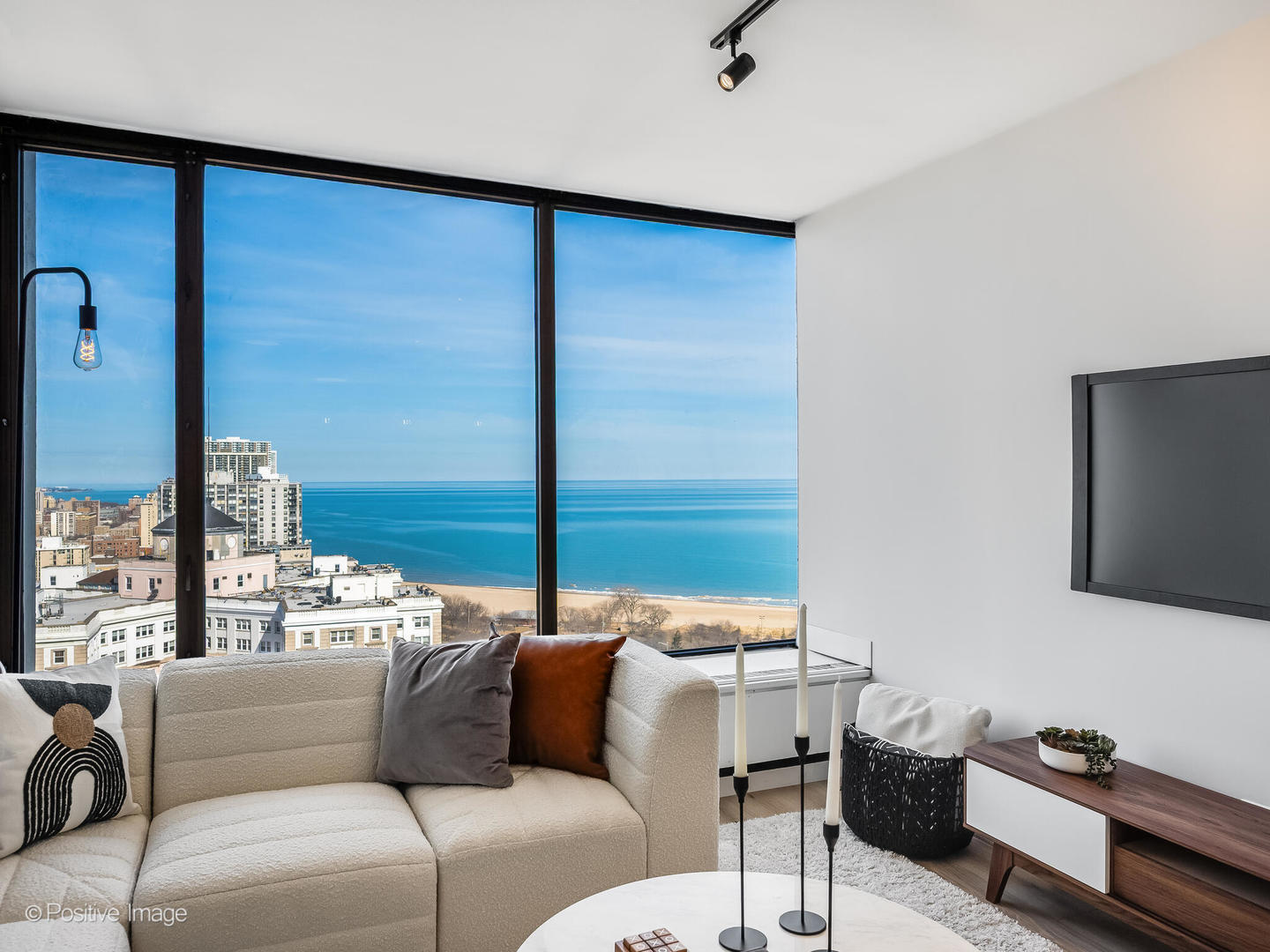 5455 North Sheridan Road, Unit 3203 Chicago, IL 60640 - Photo 5 of 21 a living room with furniture and a flat screen tv