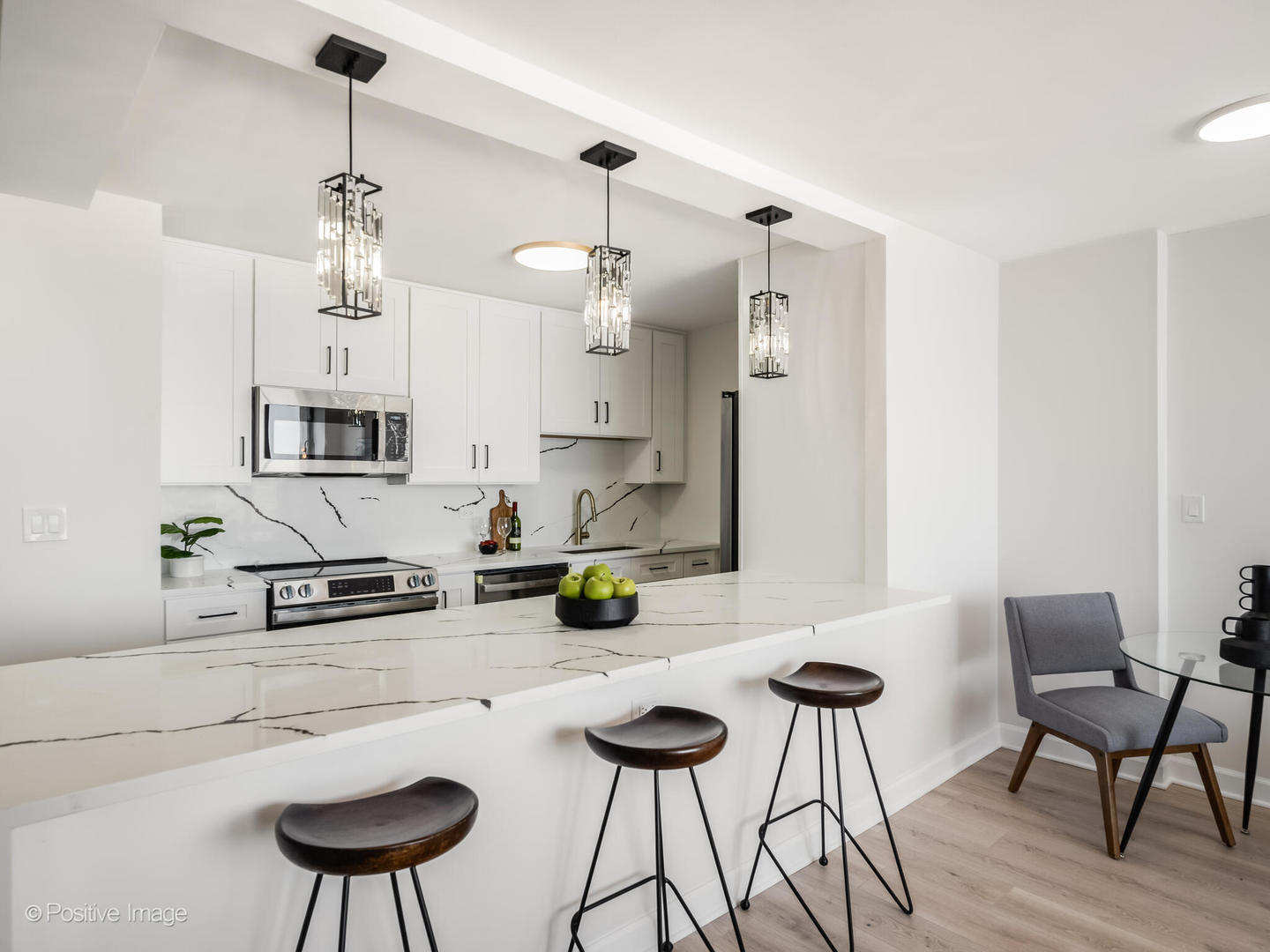 5455 North Sheridan Road, Unit 3203 Chicago, IL 60640 - Photo 8 of 21 a kitchen with stainless steel appliances granite countertop a sink and a refrigerator