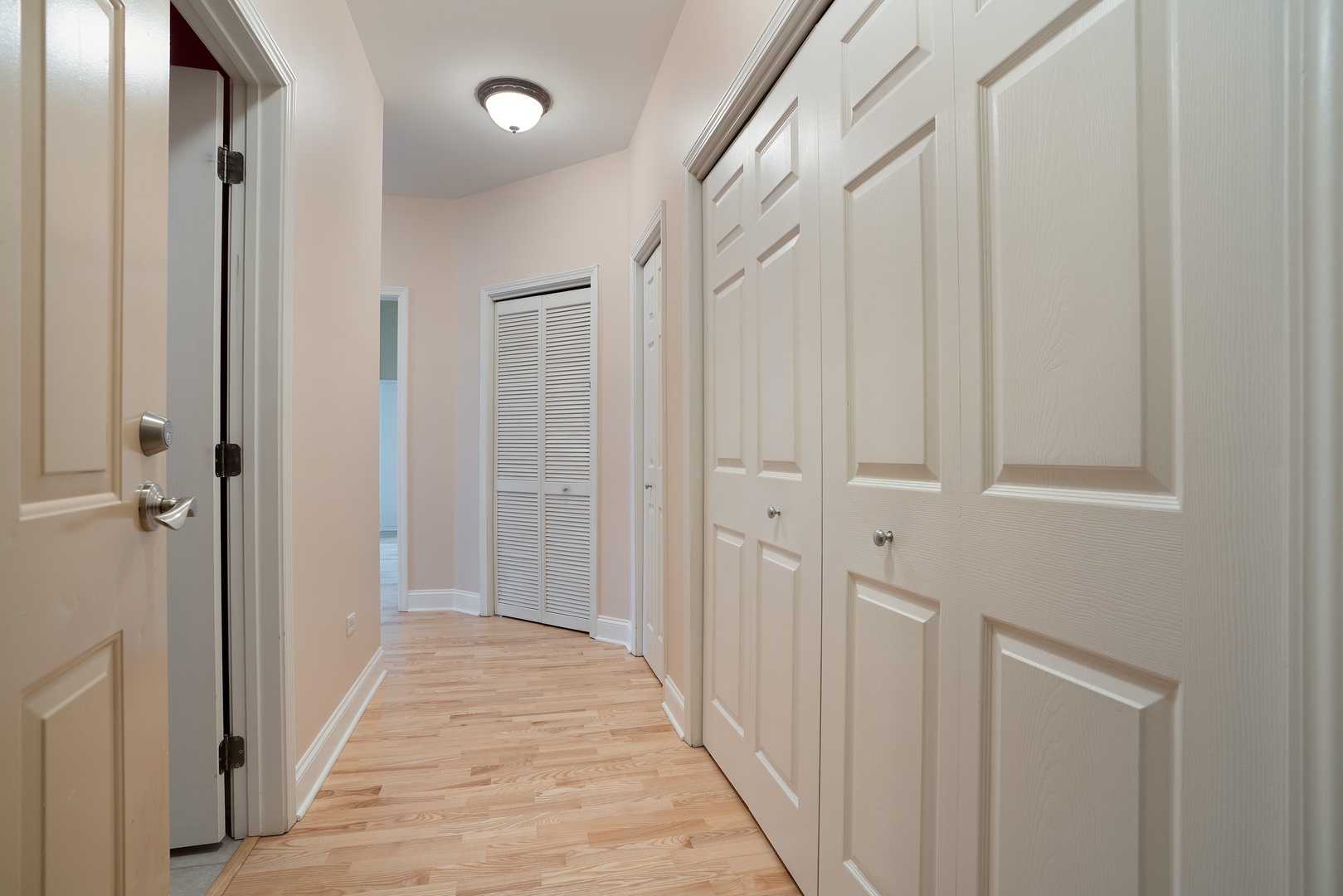 1301 West Washington Boulevard, Unit 306 Chicago, IL 60607 - Photo 2 of 11 a view of a hallway with wooden floor and a glass door
