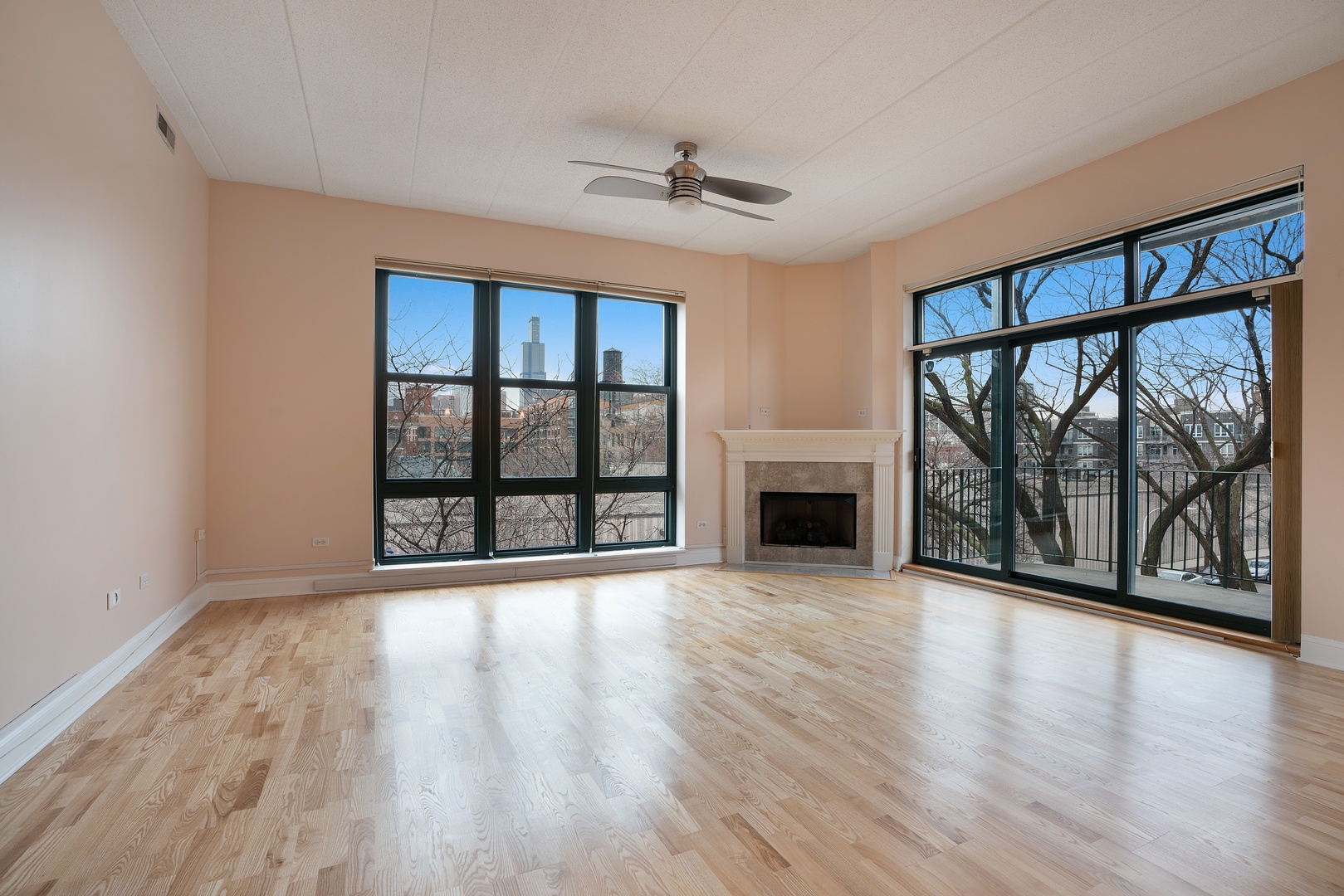 1301 West Washington Boulevard, Unit 306 Chicago, IL 60607 - Photo 3 of 11 wooden floor fireplace and windows in an room