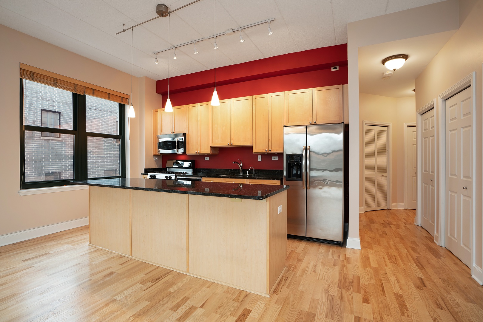 1301 West Washington Boulevard, Unit 306 Chicago, IL 60607 - Photo 5 of 11 a kitchen with stainless steel appliances granite countertop a refrigerator and microwave