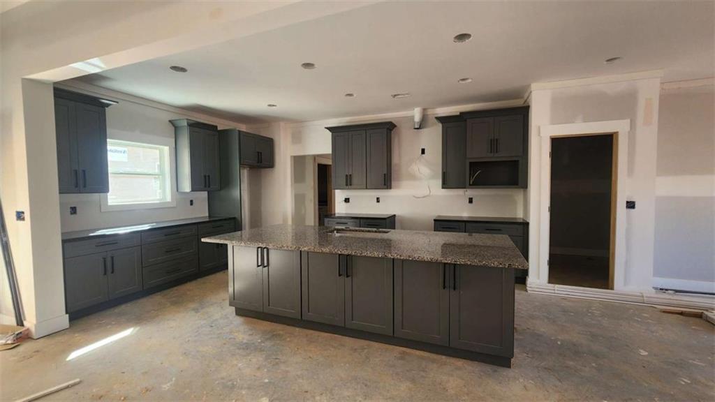 10040 Lakeview Parkway Villa Rica, GA 30180 - Photo 2 of 7 a large kitchen with stainless steel appliances kitchen island granite countertop a refrigerator and a sink