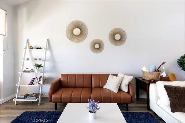 a living room with furniture and a mirror