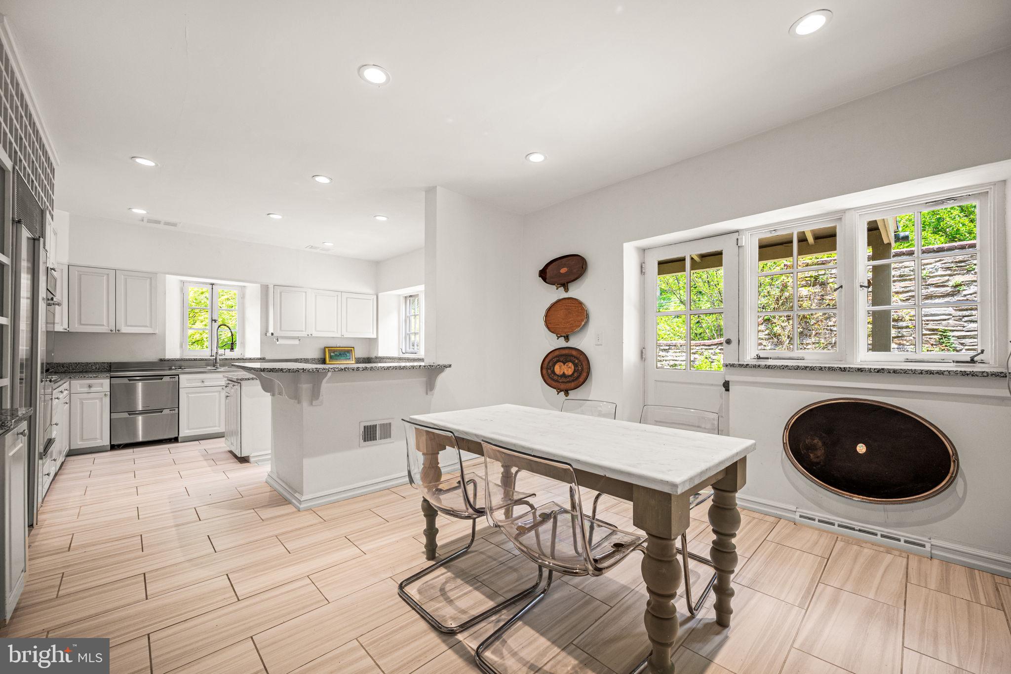 42 West Bells Mill Road Philadelphia, PA 19118 - Photo 11 of 43 a open kitchen with a table and chairs