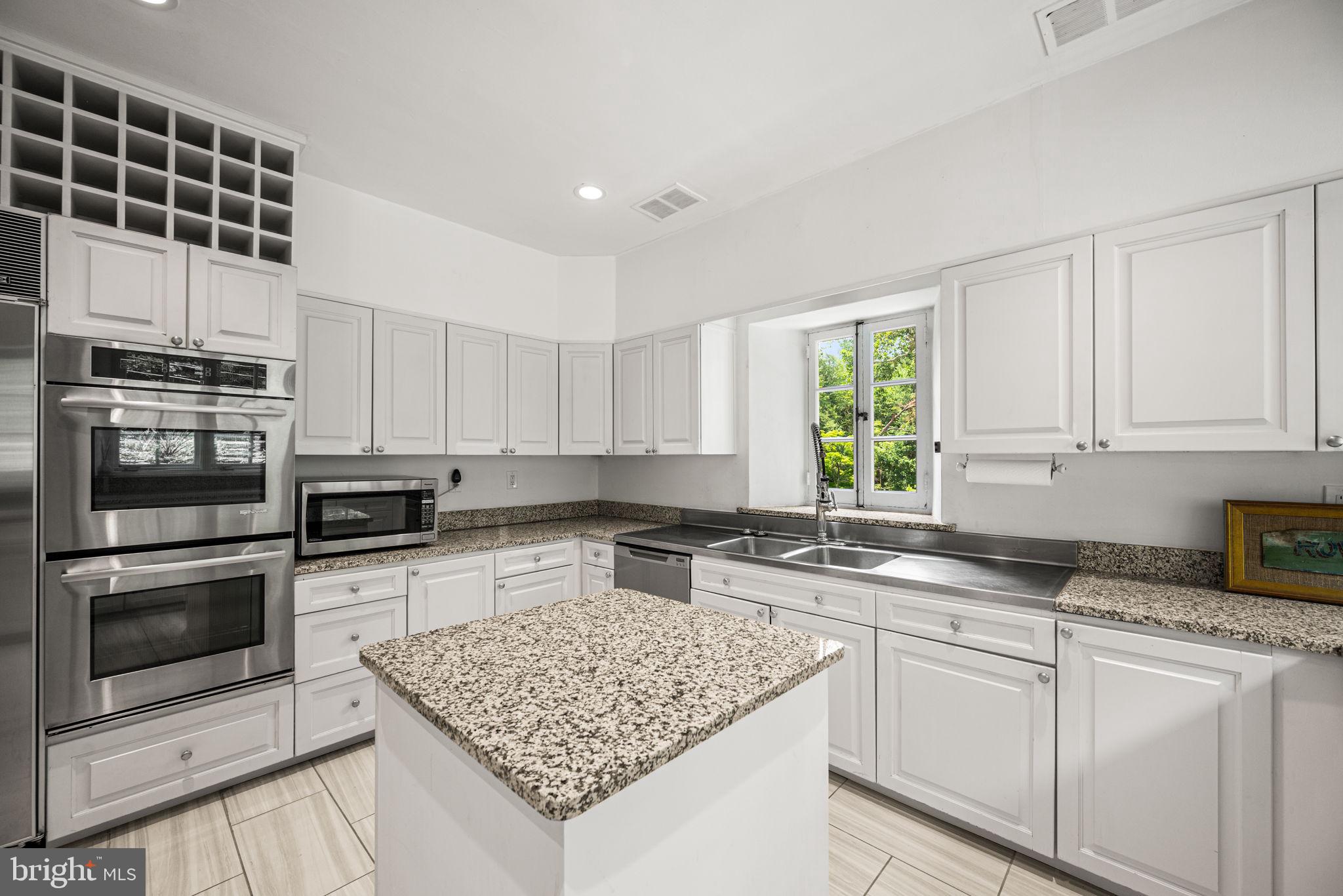 42 West Bells Mill Road Philadelphia, PA 19118 - Photo 13 of 43 a kitchen with stainless steel appliances granite countertop a sink stove and microwave