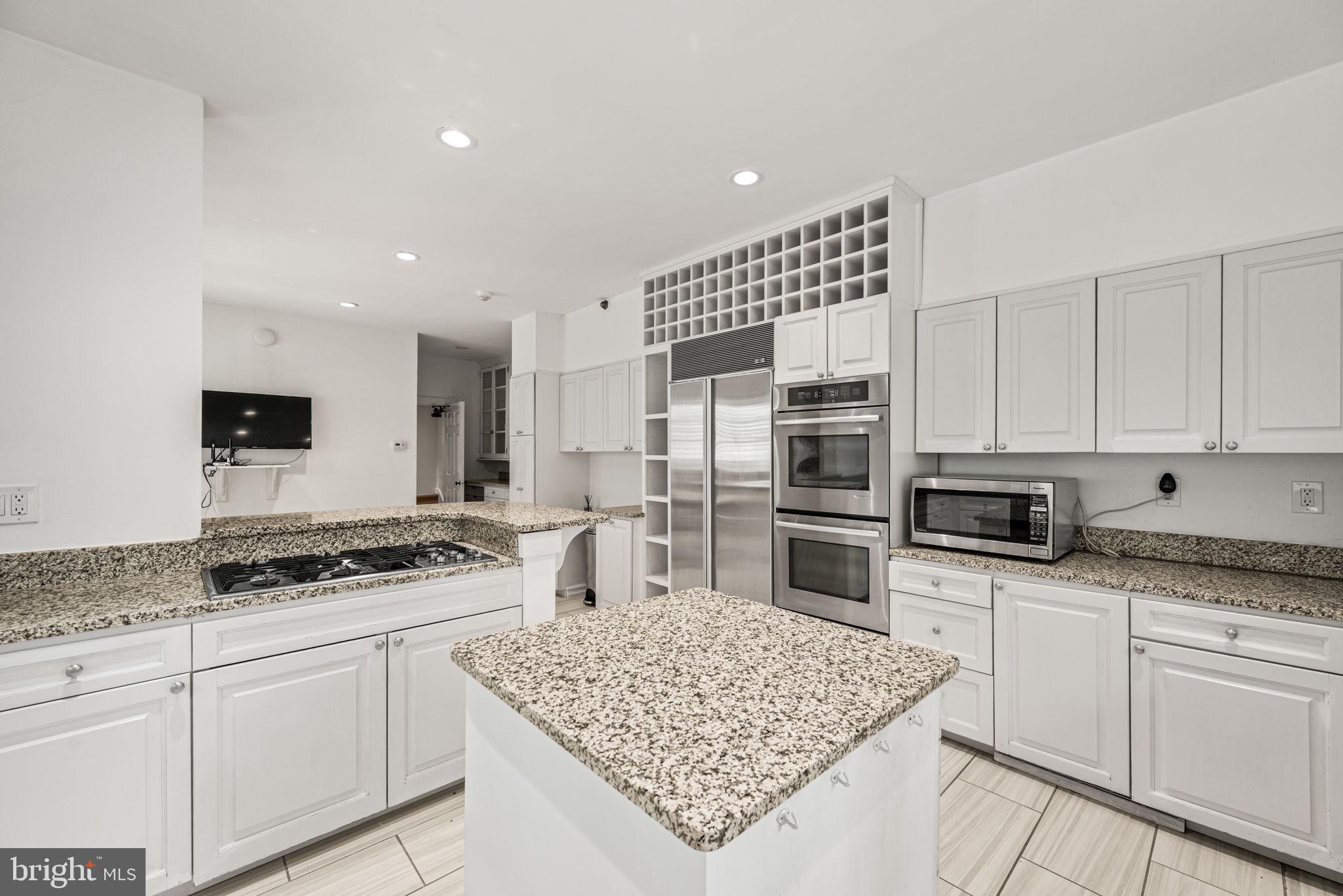 42 West Bells Mill Road Philadelphia, PA 19118 - Photo 14 of 43 a kitchen with stainless steel appliances granite countertop a sink stove and refrigerator