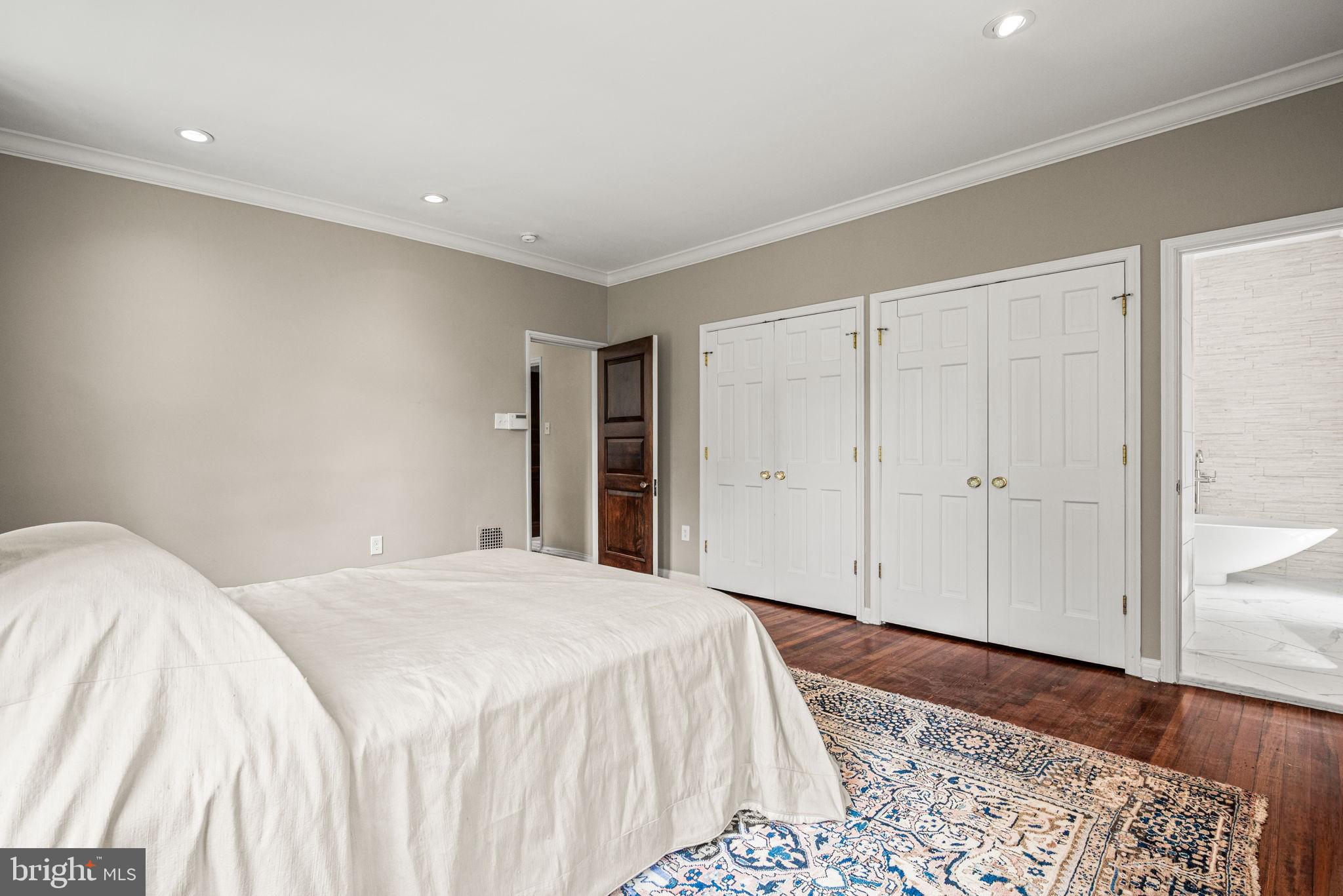 42 West Bells Mill Road Philadelphia, PA 19118 - Photo 18 of 43 a spacious bedroom with a bed and wooden floor