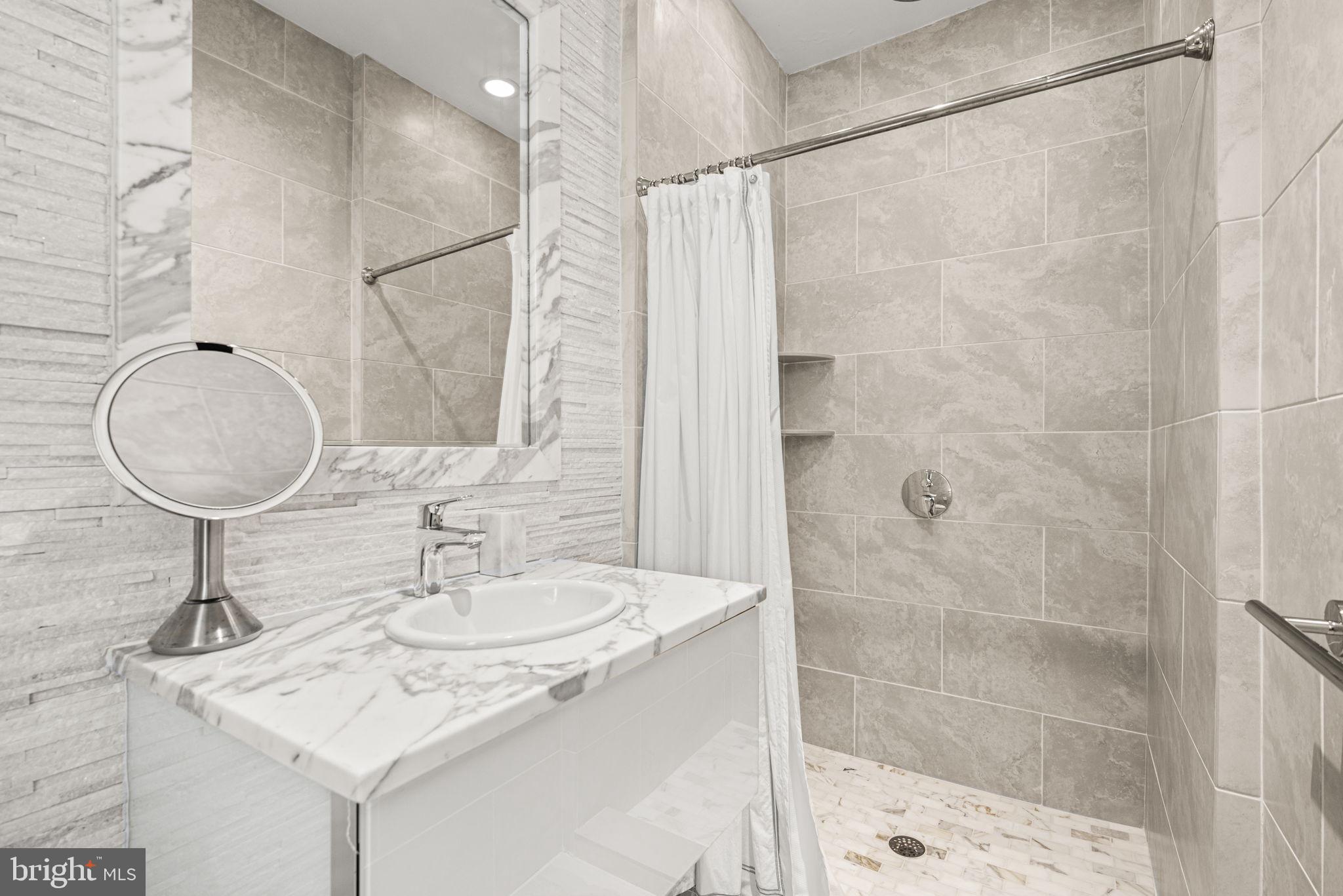 42 West Bells Mill Road Philadelphia, PA 19118 - Photo 24 of 43 a bathroom with a sink shower and a mirror