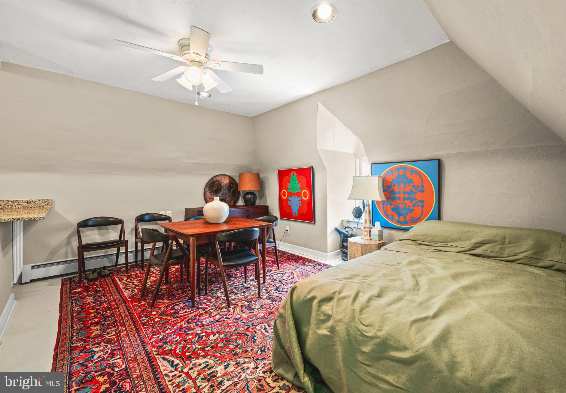 42 West Bells Mill Road Philadelphia, PA 19118 - Photo 32 of 43 a bed sitting in a bedroom next to a dining table with rug