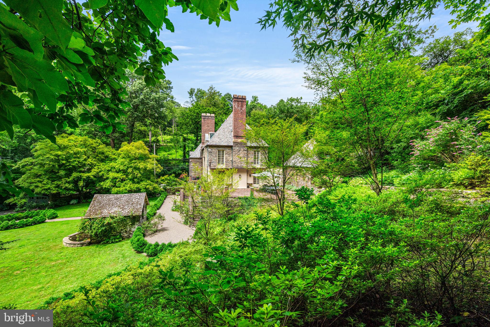 42 West Bells Mill Road Philadelphia, PA 19118 - Photo 34 of 43 a front view of a house with a yard and fountain