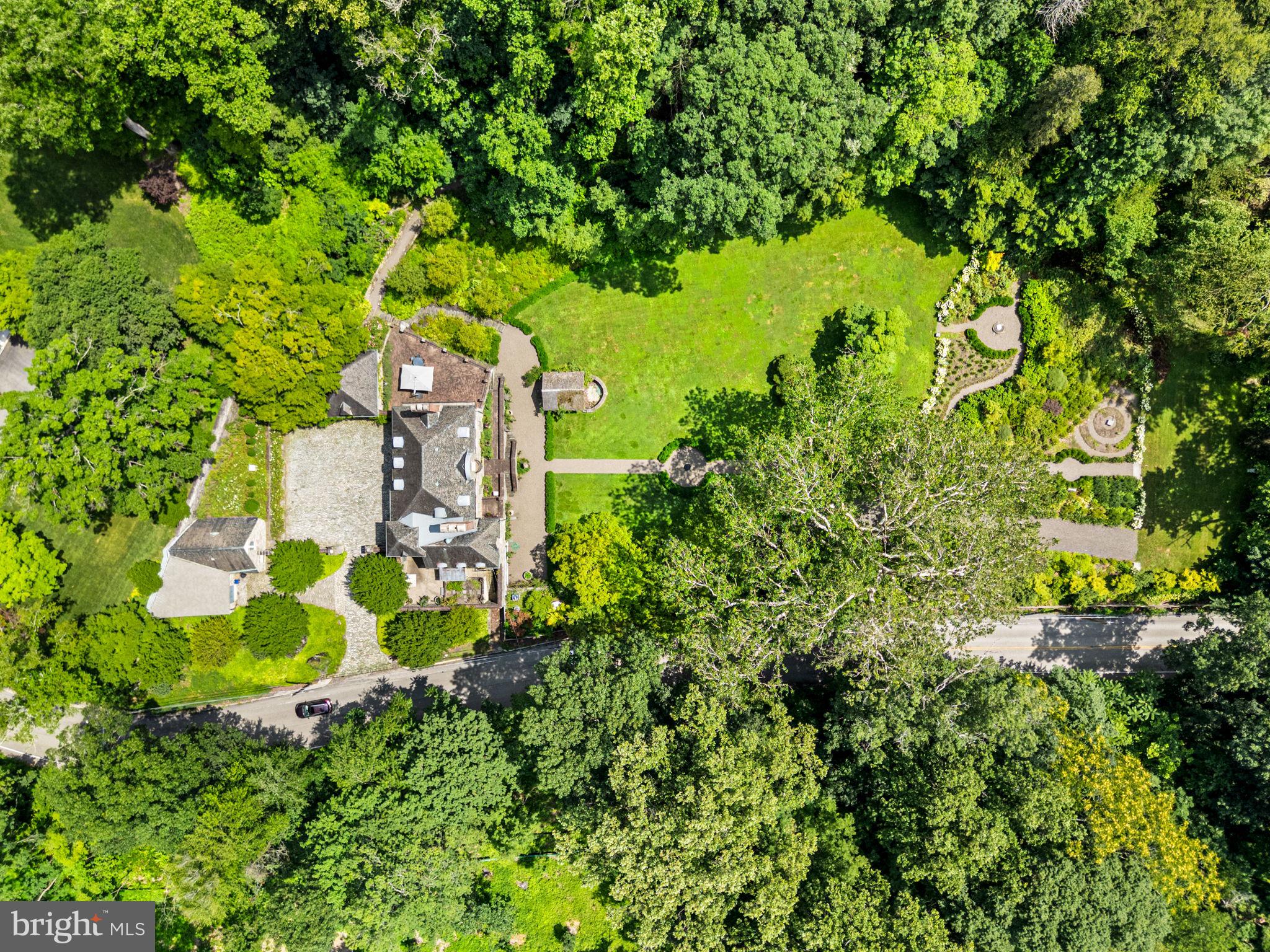42 West Bells Mill Road Philadelphia, PA 19118 - Photo 42 of 43 a backyard of a house with lots of green space