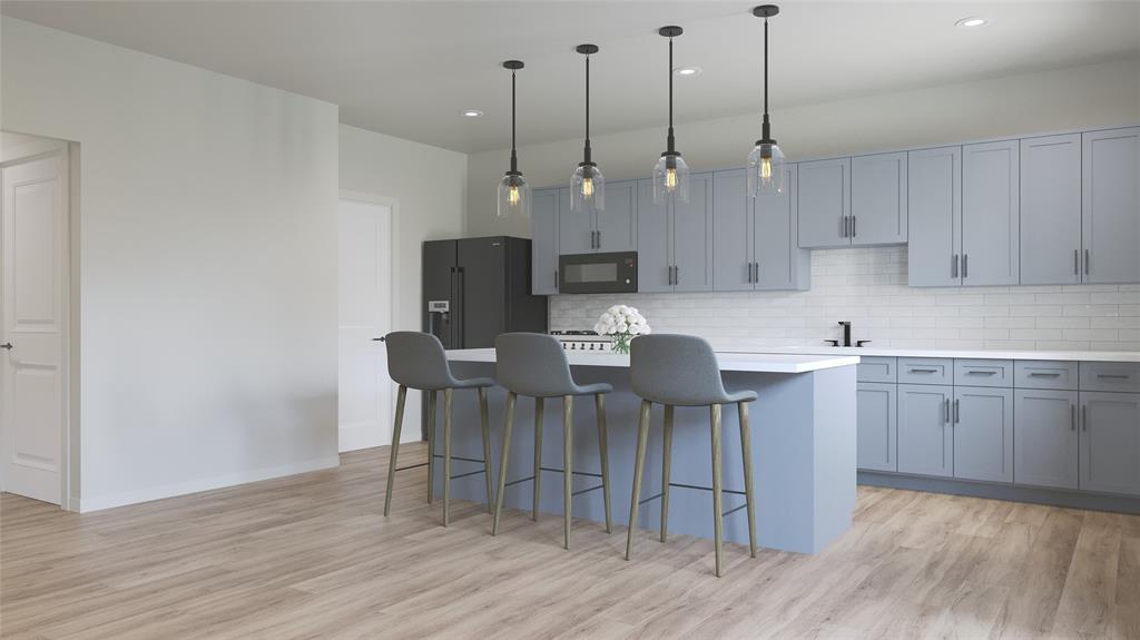 457 Lessie Circle Kennedale, TX 76060 - Photo 7 of 18 a open kitchen with a sink dishwasher a kitchen island with wooden cabinets and floors